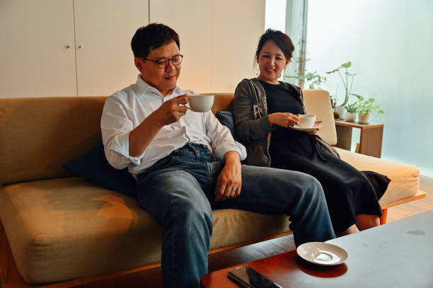 istock Mature asian couple having a coffee on Christmas 1340202740
