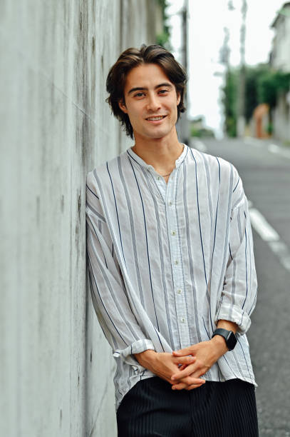 istock Young asian man's portrait on a street 1340202887