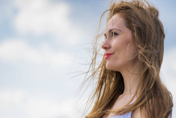 istock Brown long hair blowing in the wind against sky. 1340203749