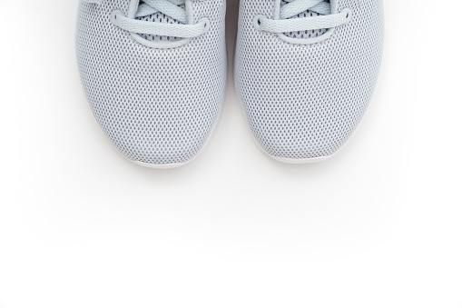 Part of grey sports sneakers on a white background. adidas