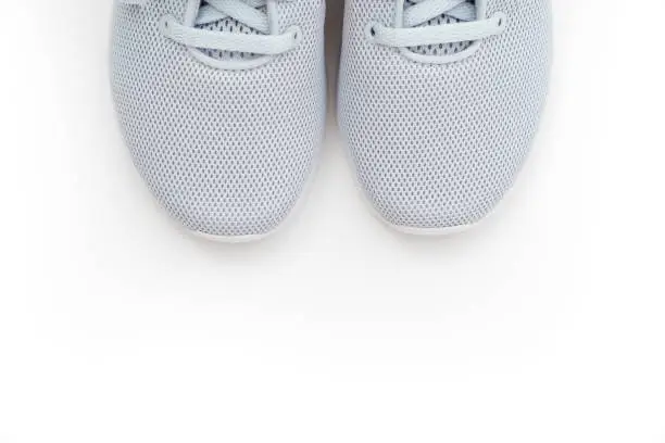 Part of grey sports sneakers on a white background. comfortable branded shoes for classes and for every day.