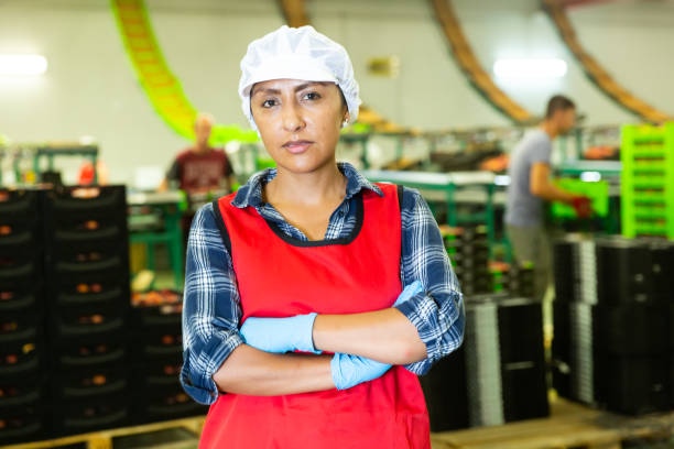 istock Latino woman worker standing at fruit warehouse 1340204045