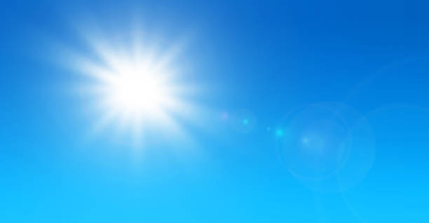 istock Sun with lens flare and blue sky background 1340207785