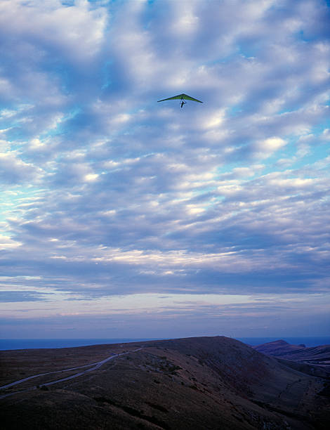 Hang glider under clouds. Hang glider under clouds. Clementyev mountain, Crimea, Ukraine. glider hang glider hanging sky stock pictures, royalty-free photos & images