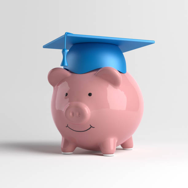 istock Piggybank and blue-colored college cap. 1340209047