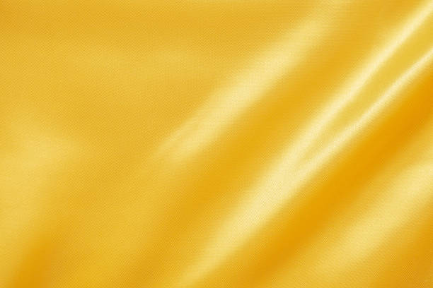 istock Abstract luxury gold fabric with soft wave texture background 1340209125