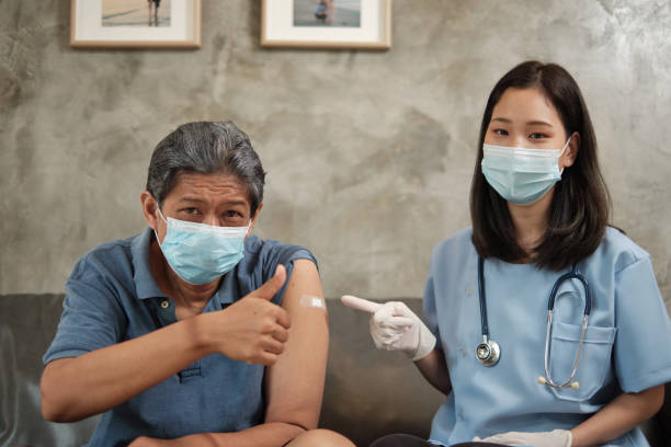 istock Elderly patient with face mask thumb up when vaccinated. 1340209769