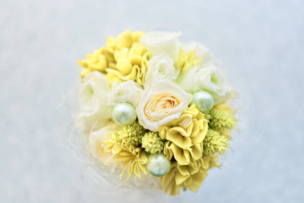 istock Green flowerpot with yellow and white flowers 1340211142