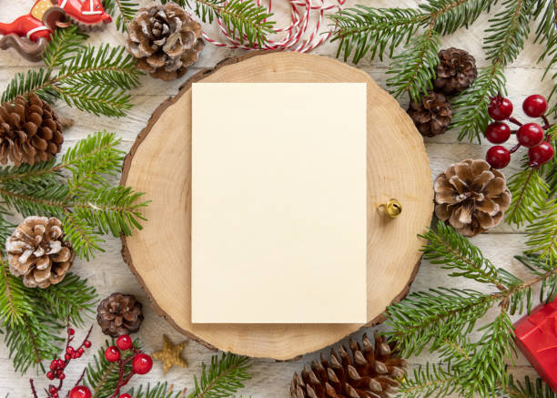 istock Christmas Composition with a blank card over wooden table flat lay. Holiday mockup 1340211309
