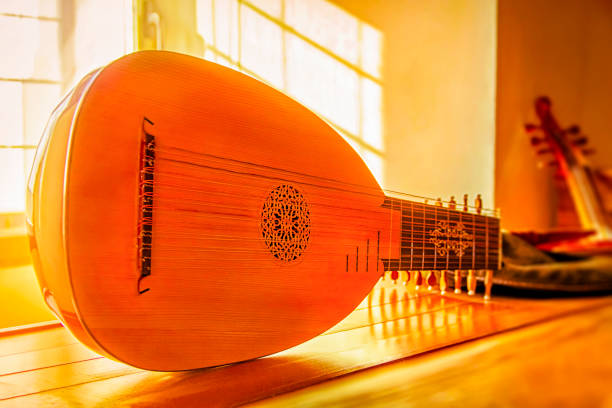 Soft focus. Medieval mandolin close-up, selective focus in the golden glow from the sun rays from the window