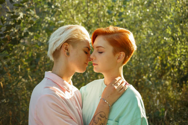 istock Lesbian languid woman hugs attractive girlfriend on meadow 1340212949