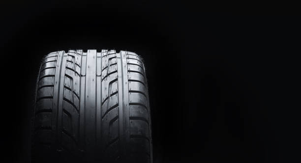 istock New car summer tire against black background with copy space 1340214039