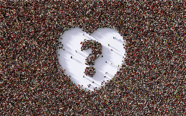 istock Human Crowd Forming Question Mark Inside Of A Human Heart Shape 1340214046