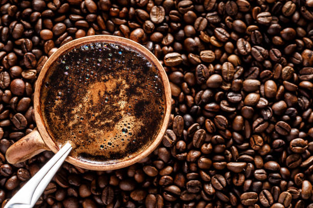istock Coffee with milk cup and roasted beans.Coffee beans wallpaper. Coffee background. Side view. 1340214413