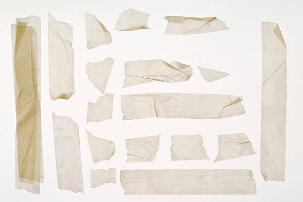 isolated shot of torn adhesive masking tape on white background - onderdeel van fotos stockfoto's en -beelden