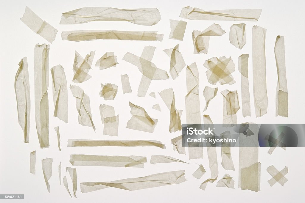 Isolated shot of torn adhesive masking tape on white background Different stripes of torn adhesive masking tape isolated on white background. Paper Stock Photo