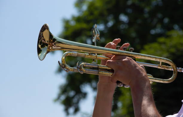 istock playing a brass instrument. military band performs at the festival 1340218070