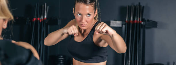 istock Woman training hard boxing in the gym 1340218238