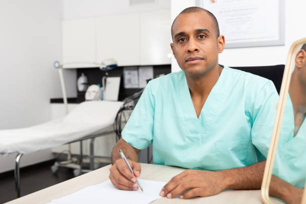 istock Male cosmetologist working with documents in aesthetic medicine office 1340218369
