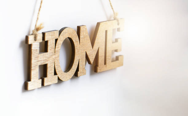 istock Home wood decorative lettering hanging on a white wall 1340218656