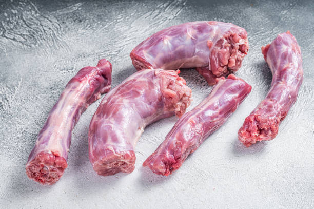 Raw Turkey neck meat on a butcher table. White background. Top View