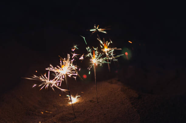 istock Romantic nighttime background with sparks. Beach sand at night w 1340220583
