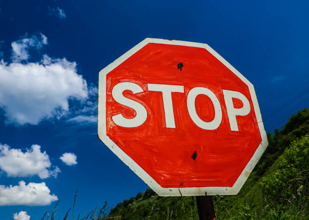 istock old stop sign on a background of blue sky with clouds 1340222237