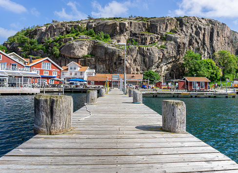 Wooden pier with a view on wonderful swedish traditional village