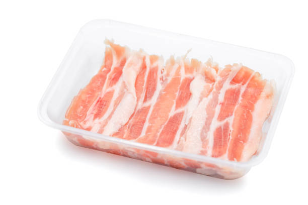 istock fresh Sliced raw pork ids isolated in plastic box on white clear background. Clipping Paths. 1340224851