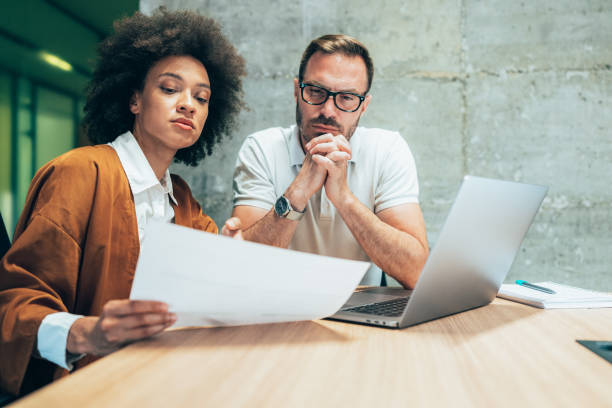 istock Two business people working together in office 1340226720