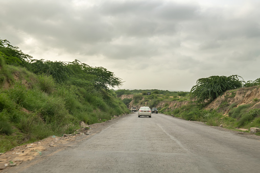 Asphalt road leading to the village