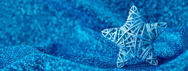 istock Christmas ornament on a blue sparkling background 1340233210