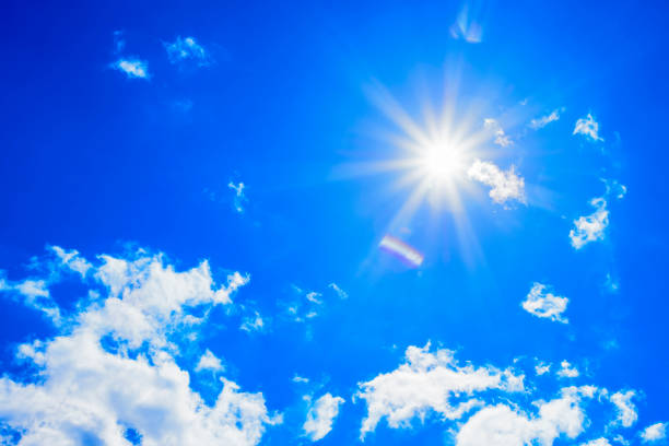 istock Bright sun with beautiful beams in the sky with light clouds 1340233352