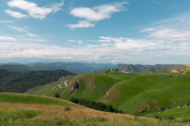 istock Panoramic view of green hills and blue mountains 1340233914