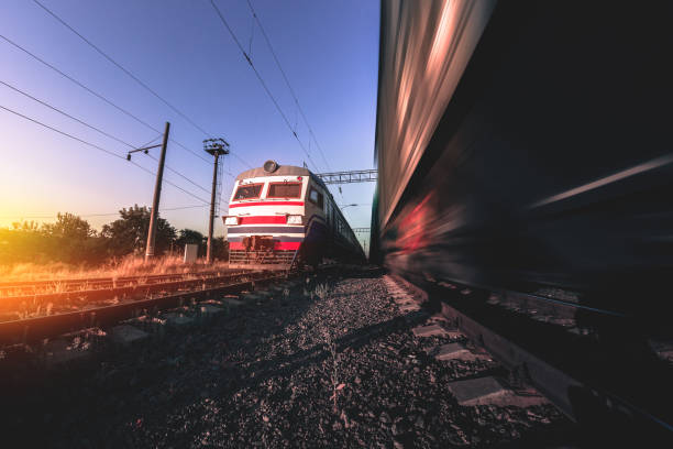 istock Freight and passenger trains on tracks with motion blur effect at sunset. Railway station in Ukraine 1340236007