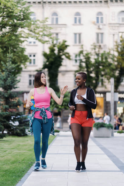 istock Two multiethnic girls walking for a exercise session, outdoor communicating. 1340236386