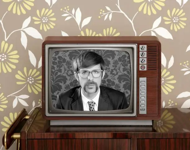Photo of nerd retro 60s vintage wooden tv presenter