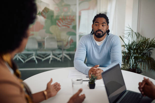istock Young African American man having a job interview at corporate office. 1340242545