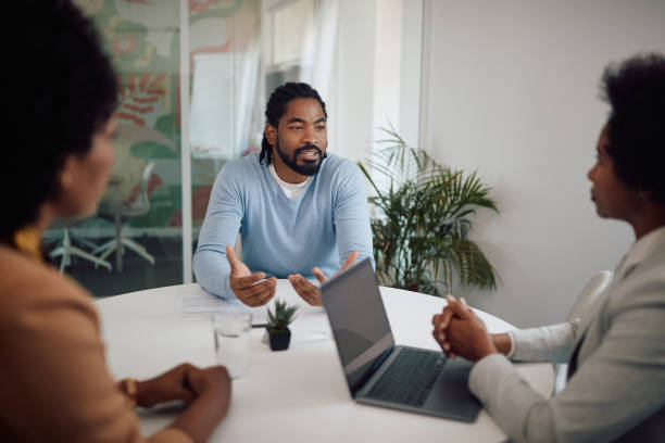 istock Young black man talking to human resource team during job interview in the office. 1340242569