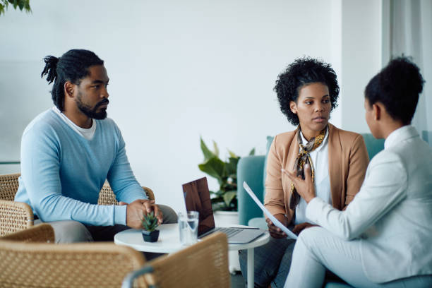 istock Young black candidate waiting while human resource team is discussing about his resume during job interview. 1340243007