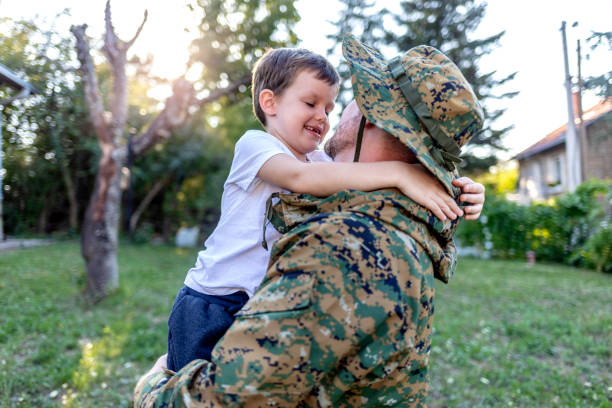 istock Boy looking proudly at his soldier father. 1340245675
