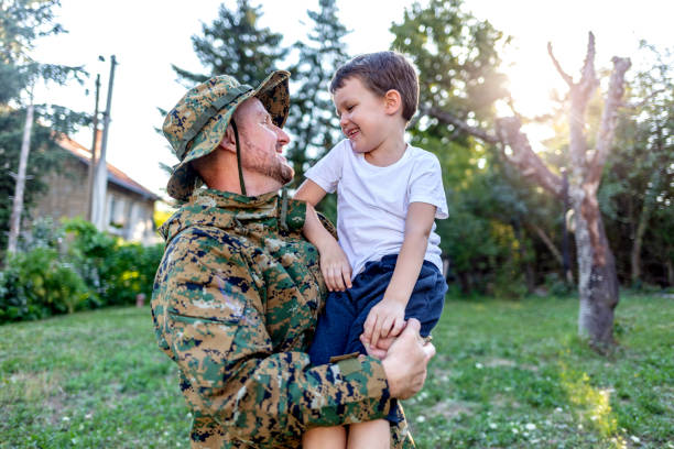 istock Boy looking proudly at his soldier father. 1340245676