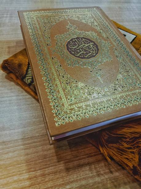 istock holy Quran and the prayer rug 1340246587