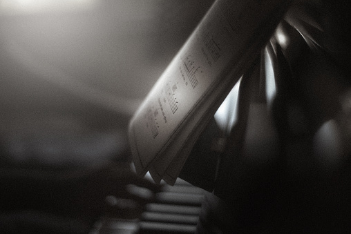 Close up shot of an unrecognizable person playing piano at home