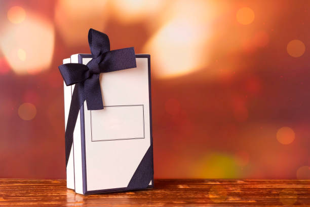istock Gift box on a burgundy background with bokeh. 1340248073
