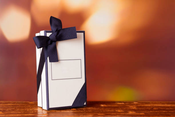 istock Gift box on a burgundy background with bokeh. 1340248148