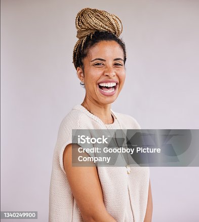 istock Stylish young businesswoman with braided hair laughing 1340249900