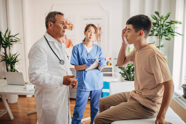 istock Doctor is talking and examining the patient at the clinic while nurse is taking notes in medical chart 1340249971