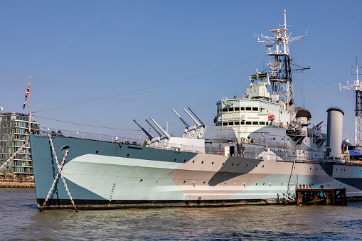 London, UK - Sep 7, 2021: eople visit HMS Belfast, famous ship moored in London. She was launched in 1938, decomissioned in 1963 and has been a museum ship since 1971.