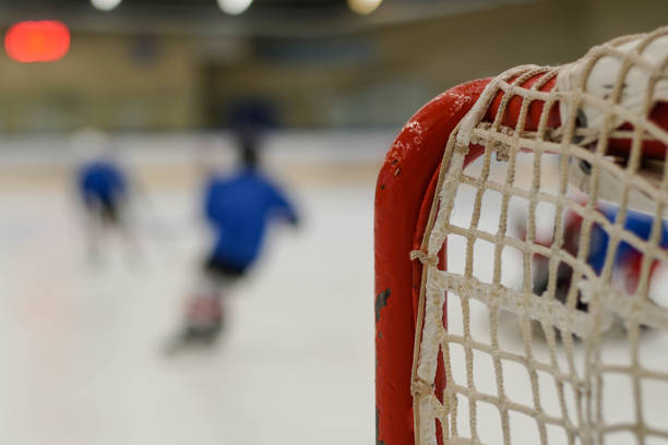 Children playing ice hockey in arena. Young hockey players practising. Children playing ice hockey in arena. Young hockey players practising. ice hockey net stock pictures, royalty-free photos & images